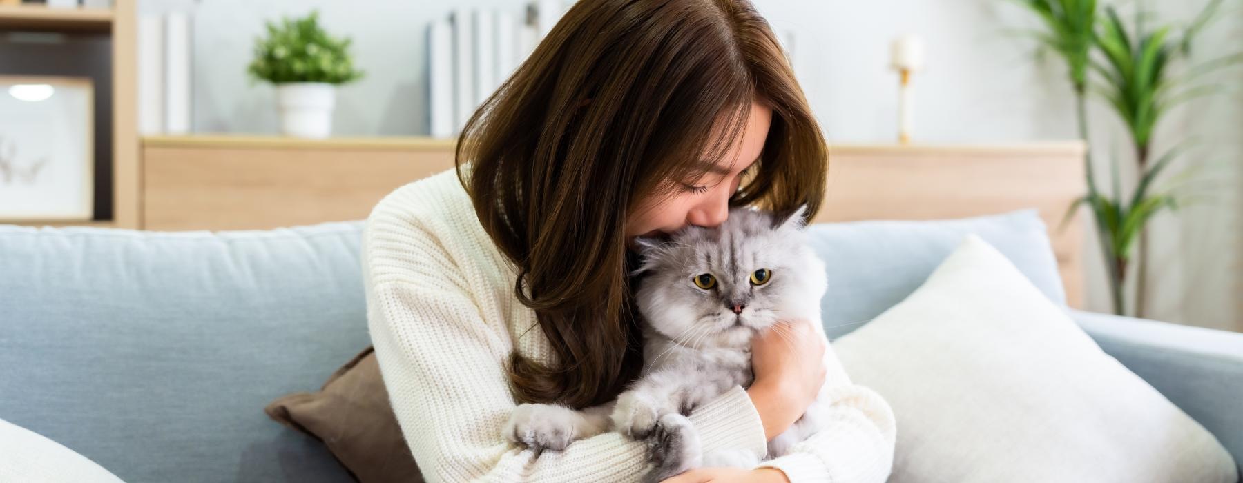 a woman holding a cat