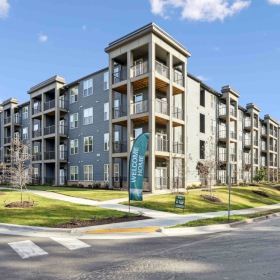 Welcome home exterior of a building off a road